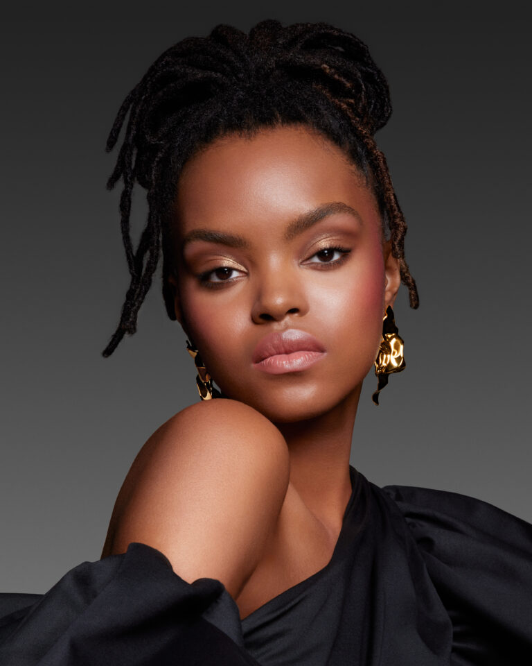 african american model with braids and one shoulder black dress