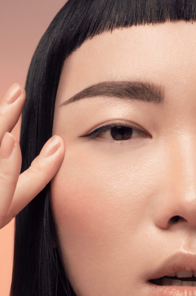 asian model touching skin near eye